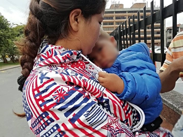 Madre venezolana con su hijo a las afueras del Terminal de Transportes