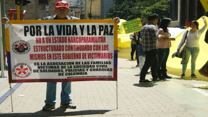 El Presidente de la asociación de las familias de las víctimas de la sociedad civil de soldados, policías y guardias de Colombia atiende la protesta