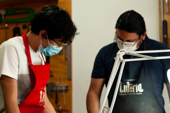 Luis Felipe y su maestro en el proceso de creación de violín.